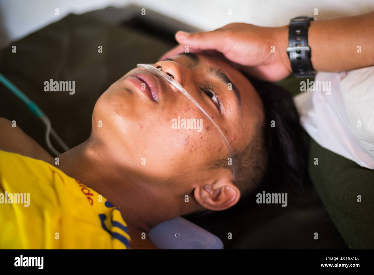 Aris, member of Indonesia U19 men team gets medical treatment after down river race category during the 2015 World Rafting Championships. Stock Photo