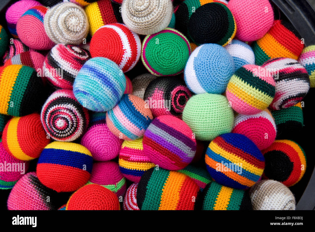 Colorful fabric balls on display in marketplace in Otavalo, Ecuador, South America Stock Photo