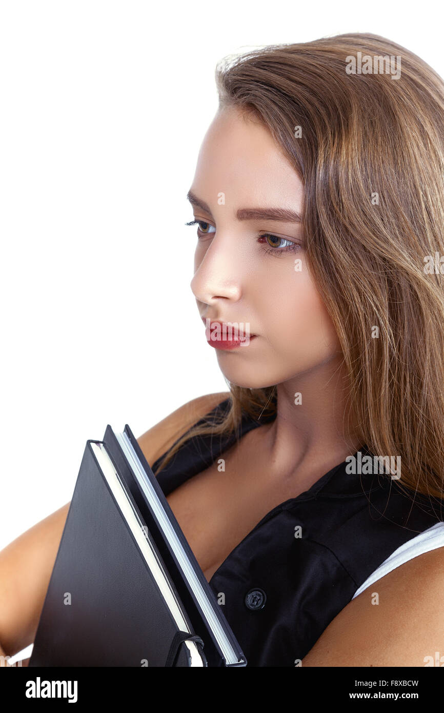 One Young cheerful woman student holding books and looking away Stock Photo