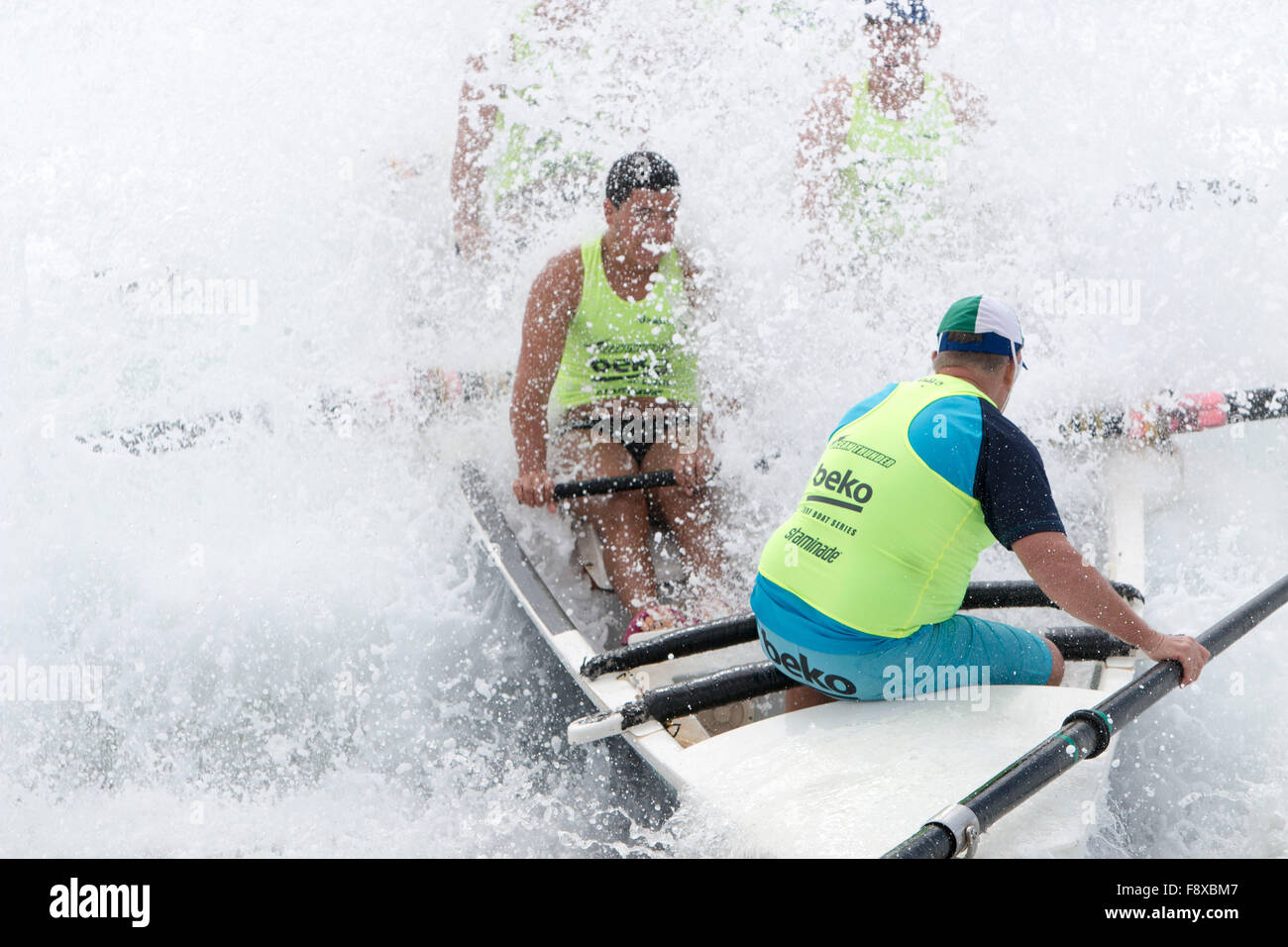 Sydney, Australia. 12th December, 2015. Ocean Thunder Annual Series of Professional surfboat racing from Dee Why Beach which involves 24 elite mens teams and 12 elite womens teams from around Australia. Mens team drenched as the boat hits large wave and the sweep struggles to maintain control of the surfboat Credit:  model10/Alamy Live News Stock Photo