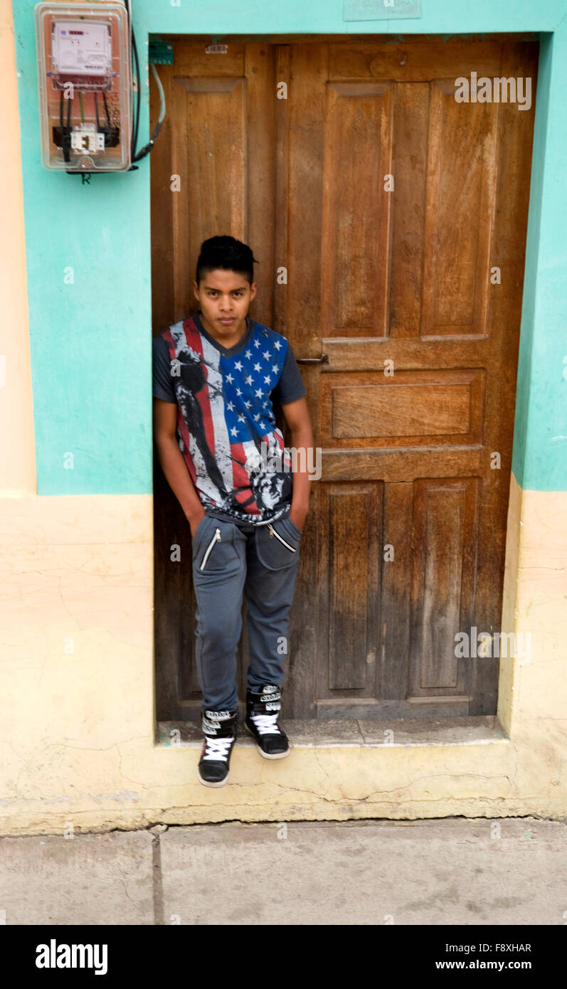 Young boy in American flag themed t-shirt watching passing train en route to  Salinas from Ibarra, Ecuador Stock Photo