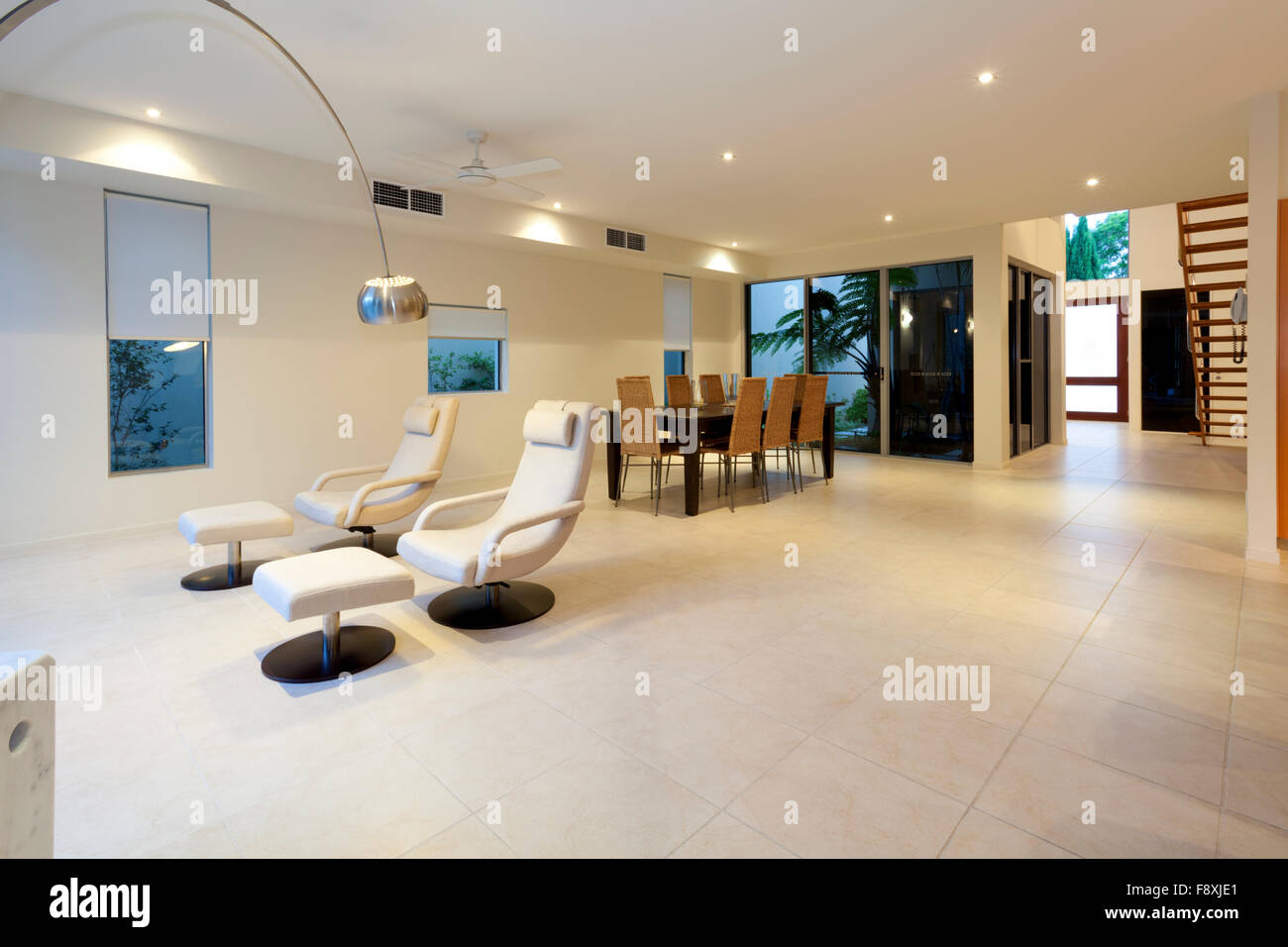 Luxurious Dining Table And Living Area With Two Designer Recliner Chairs And Lamp Stock Photo Alamy