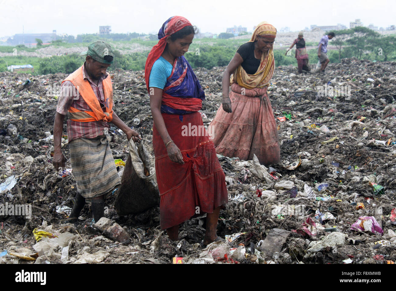 Male and Female waste pickers pick the non biodegradable waste to be