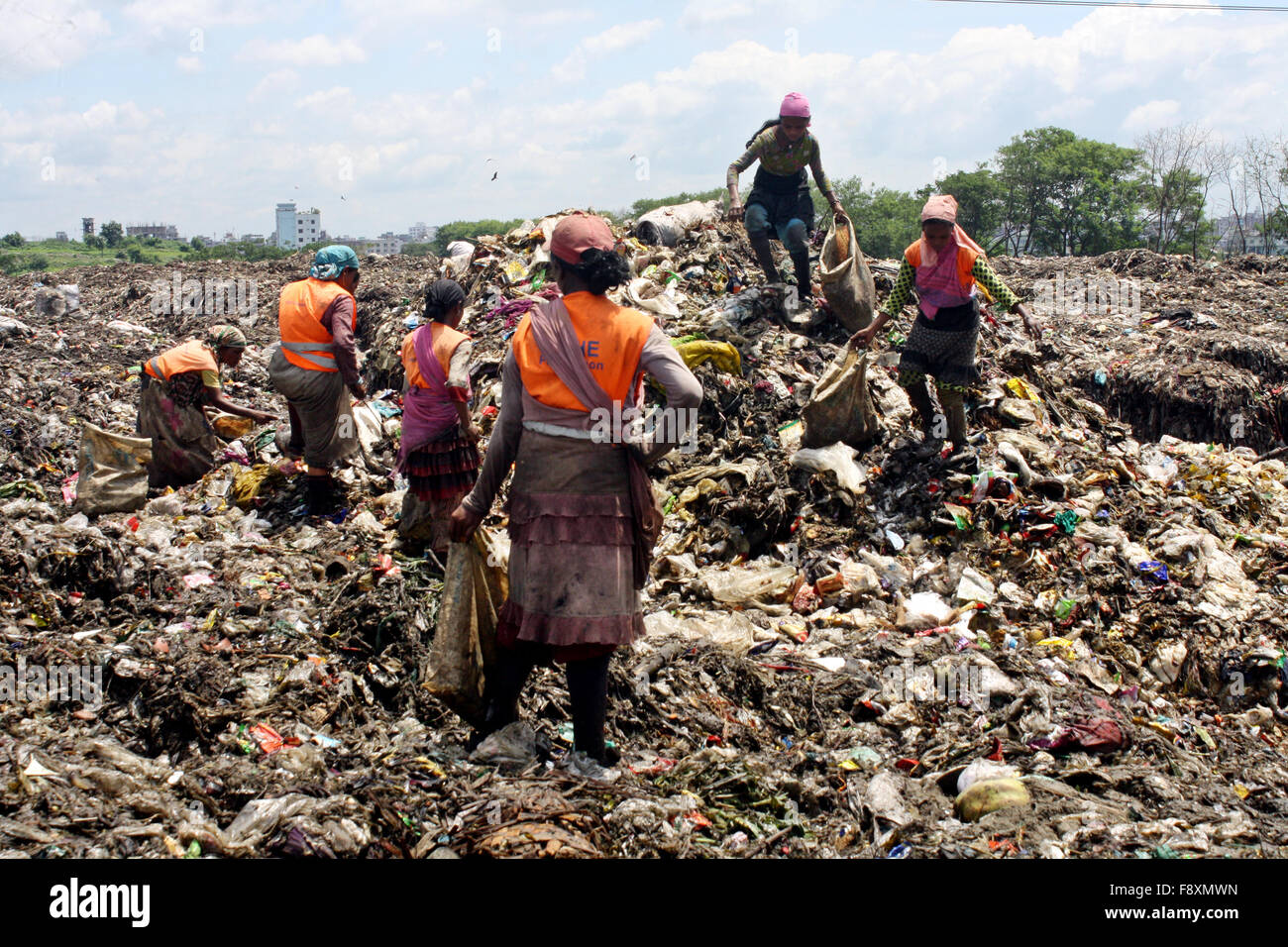 Male and Female waste pickers pick the non- biodegradable waste to be ...