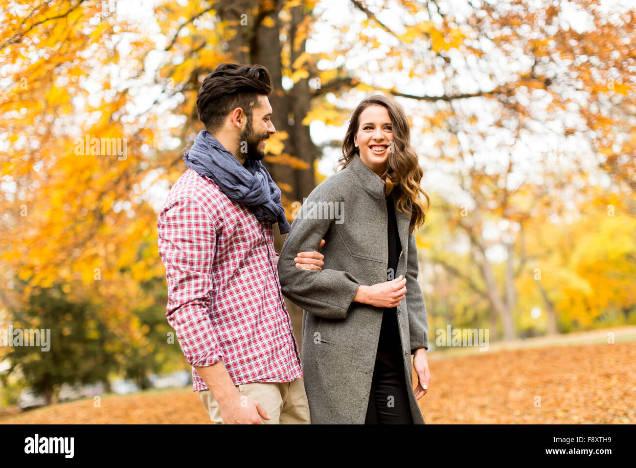Young couple in the autumn park Stock Photo - Alamy
