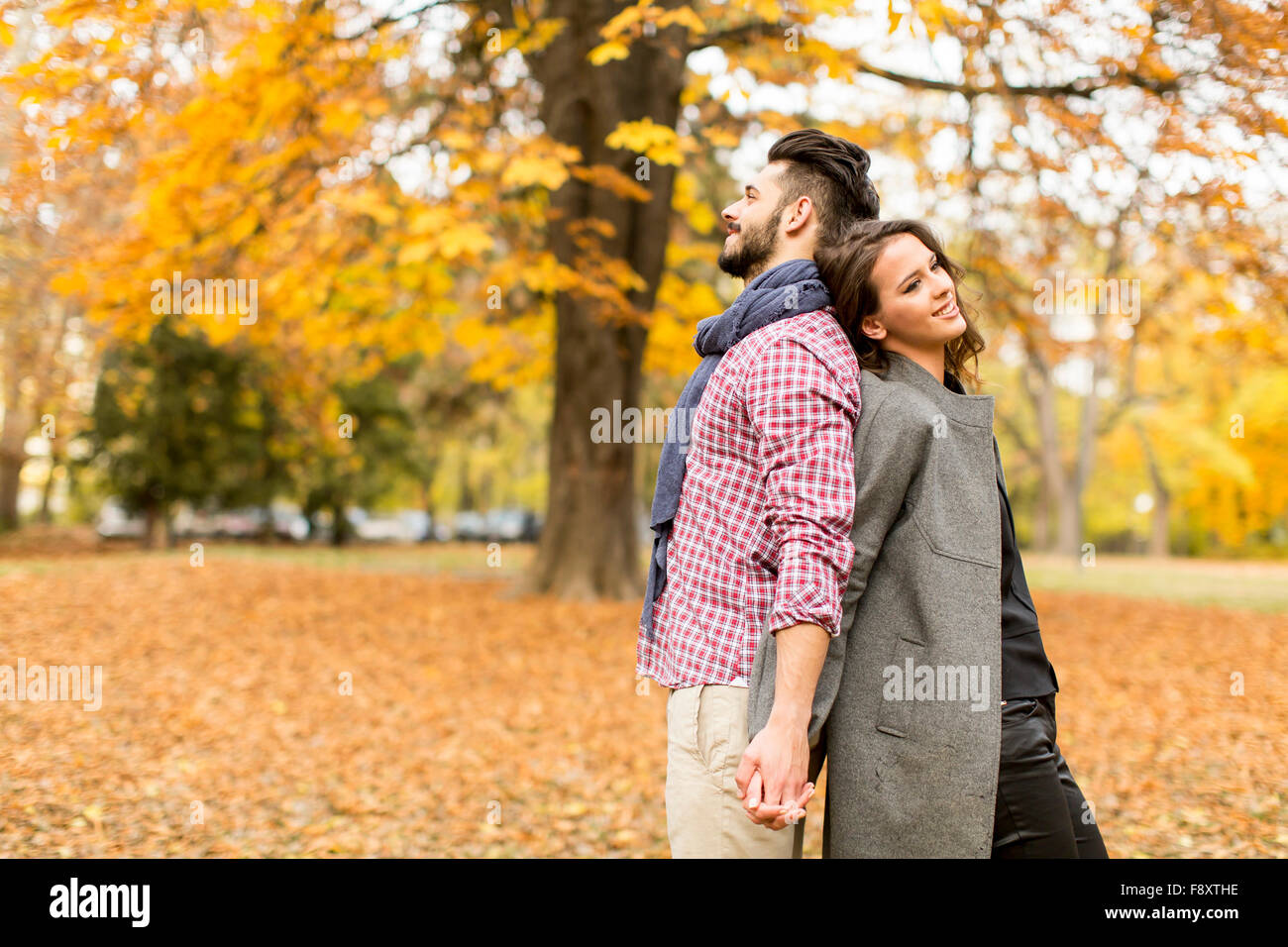 Young couple in the autumn park Stock Photo - Alamy