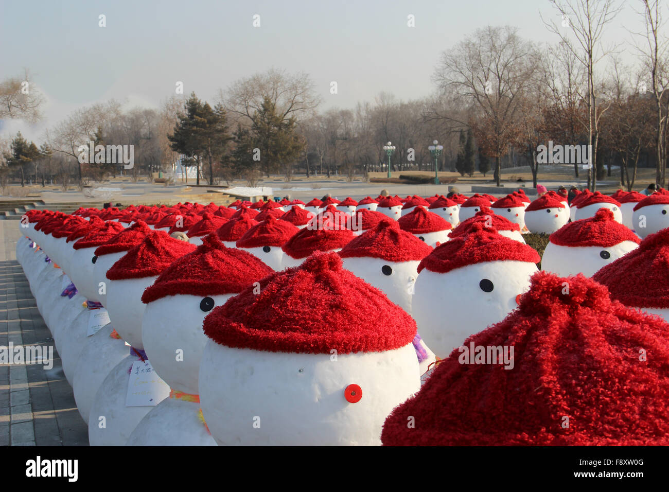Snow men line up with red cap in a forest Stock Photo