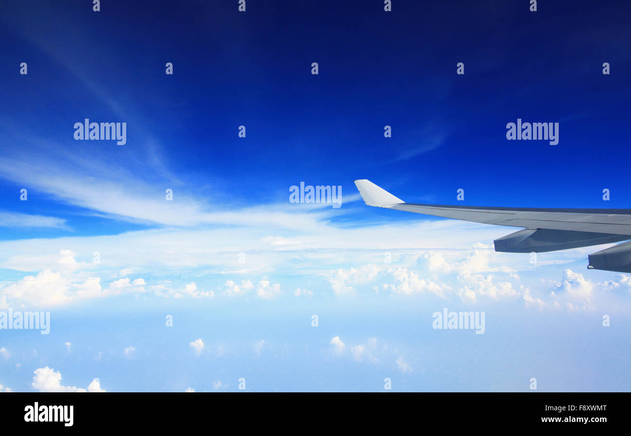 Airplan wing in blue sky over the cloudy Stock Photo - Alamy