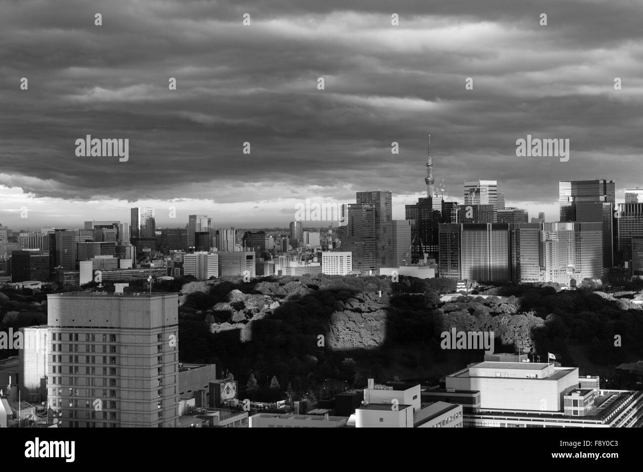 Shadows pointing at the Tokyo Sky Tree over the Imperial Palace under a stormy sky Stock Photo