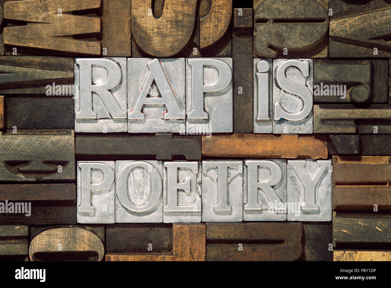 rap is poetry phrase made from metallic letterpress blocks in mixed wooden letters Stock Photo