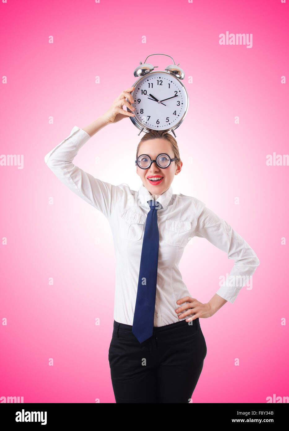 Nerd businesswoman with gian alarm clock Stock Photo - Alamy