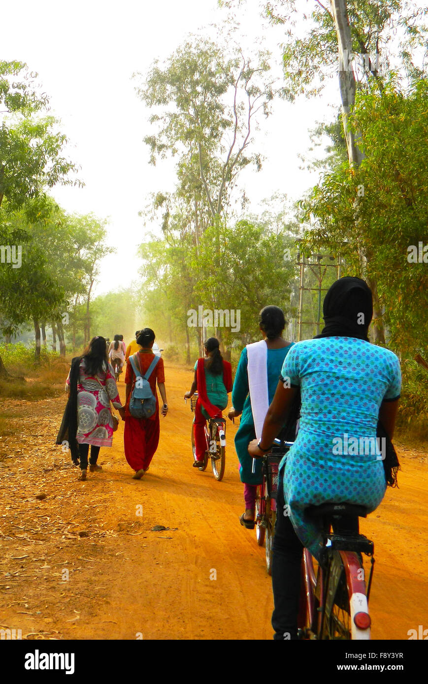 Way Back to Home, Busy Road with Cycling Girls and Pedestrian Stock Photo