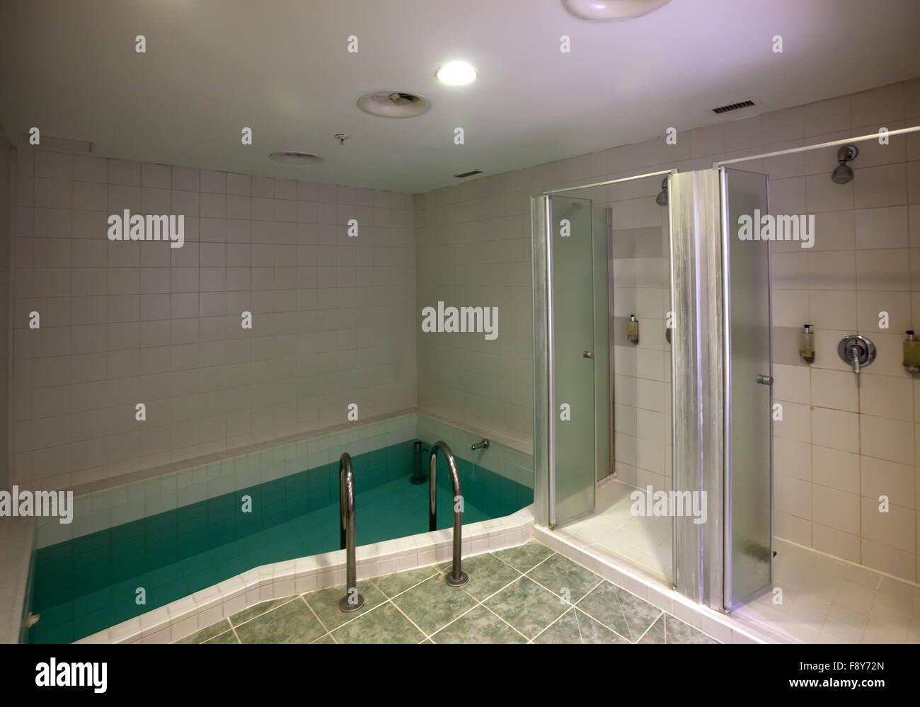 Interior of swimming pool with shower Stock Photo - Alamy