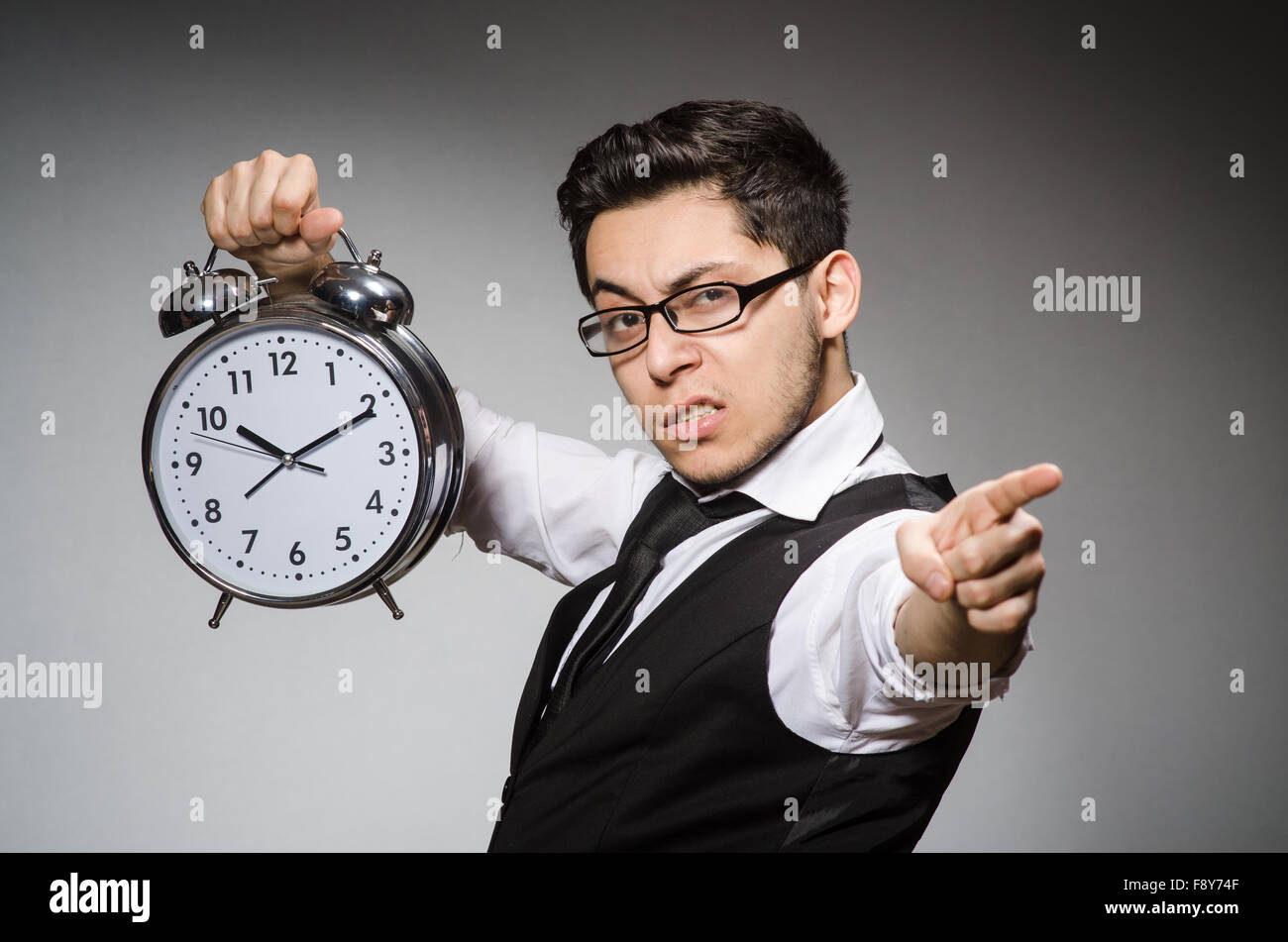 Businessman with clock in time concept Stock Photo - Alamy