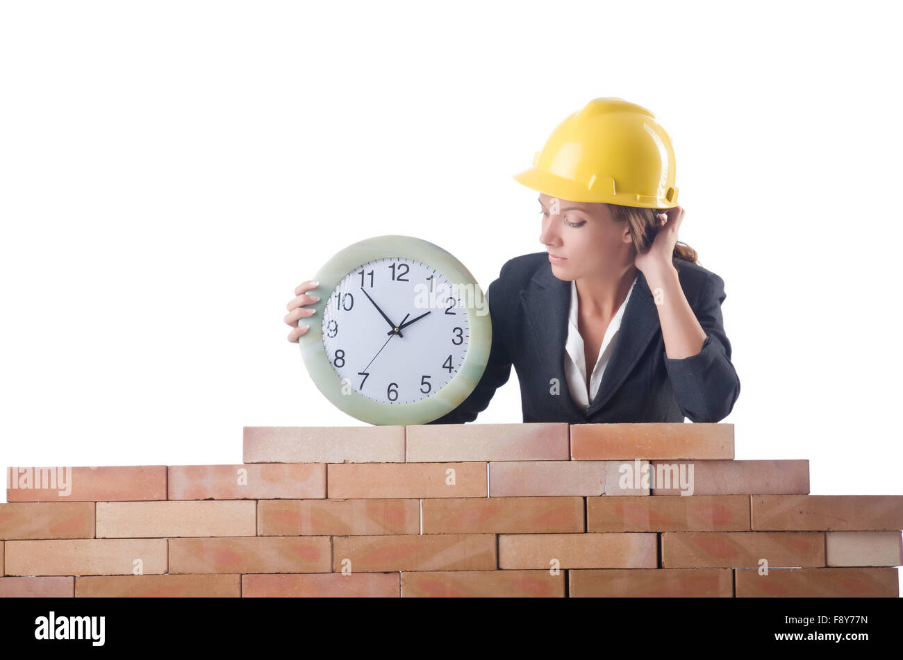 Woman construction worker with clock on white Stock Photo - Alamy