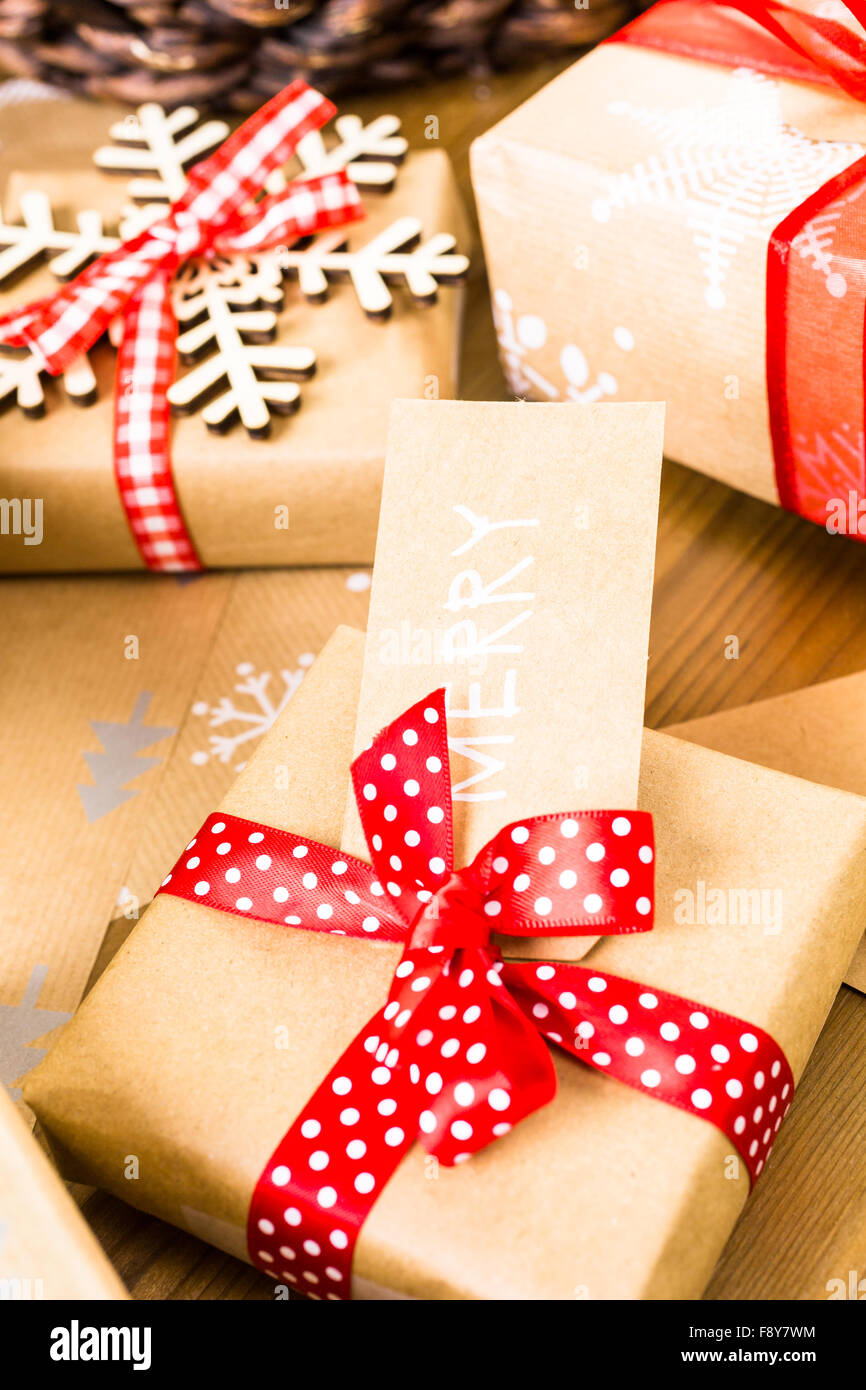 Christmas gifts wrapped in brown paper with red ribbons Stock Photo Alamy