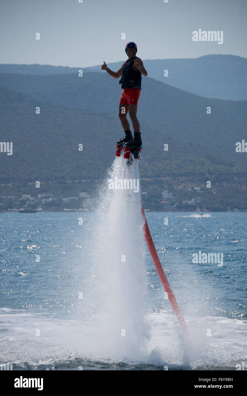 Flyboarder high above water with thumbs up Stock Photo - Alamy