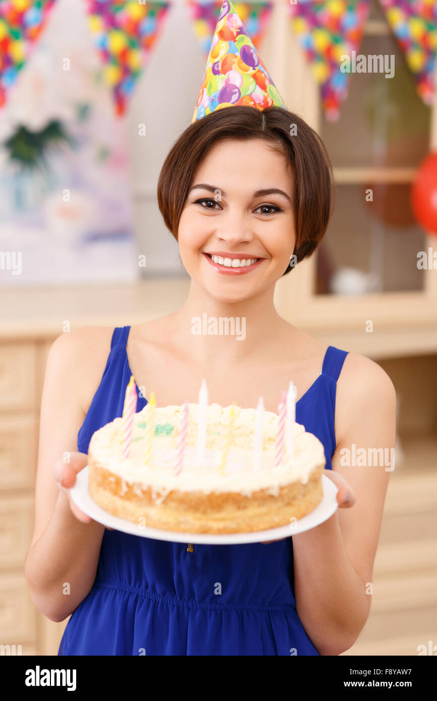 Young smiling girl is holding her birthday cake Stock Photo Alamy