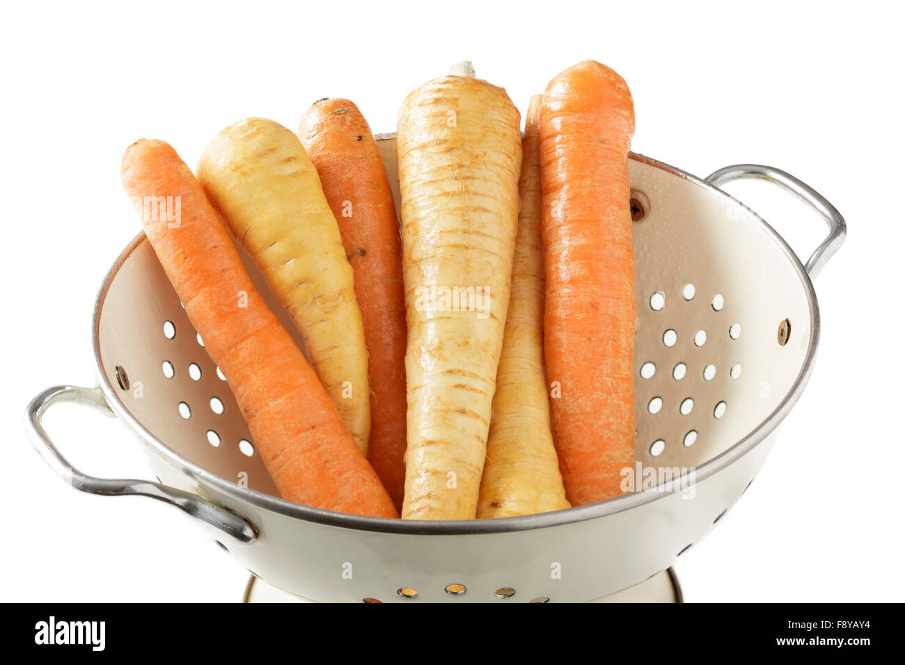 Carrots and parsnips in colander Stock Photo