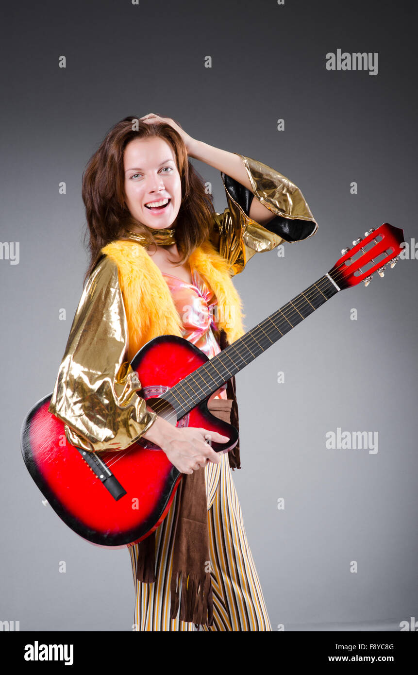 Guitar player with red instrument Stock Photo - Alamy