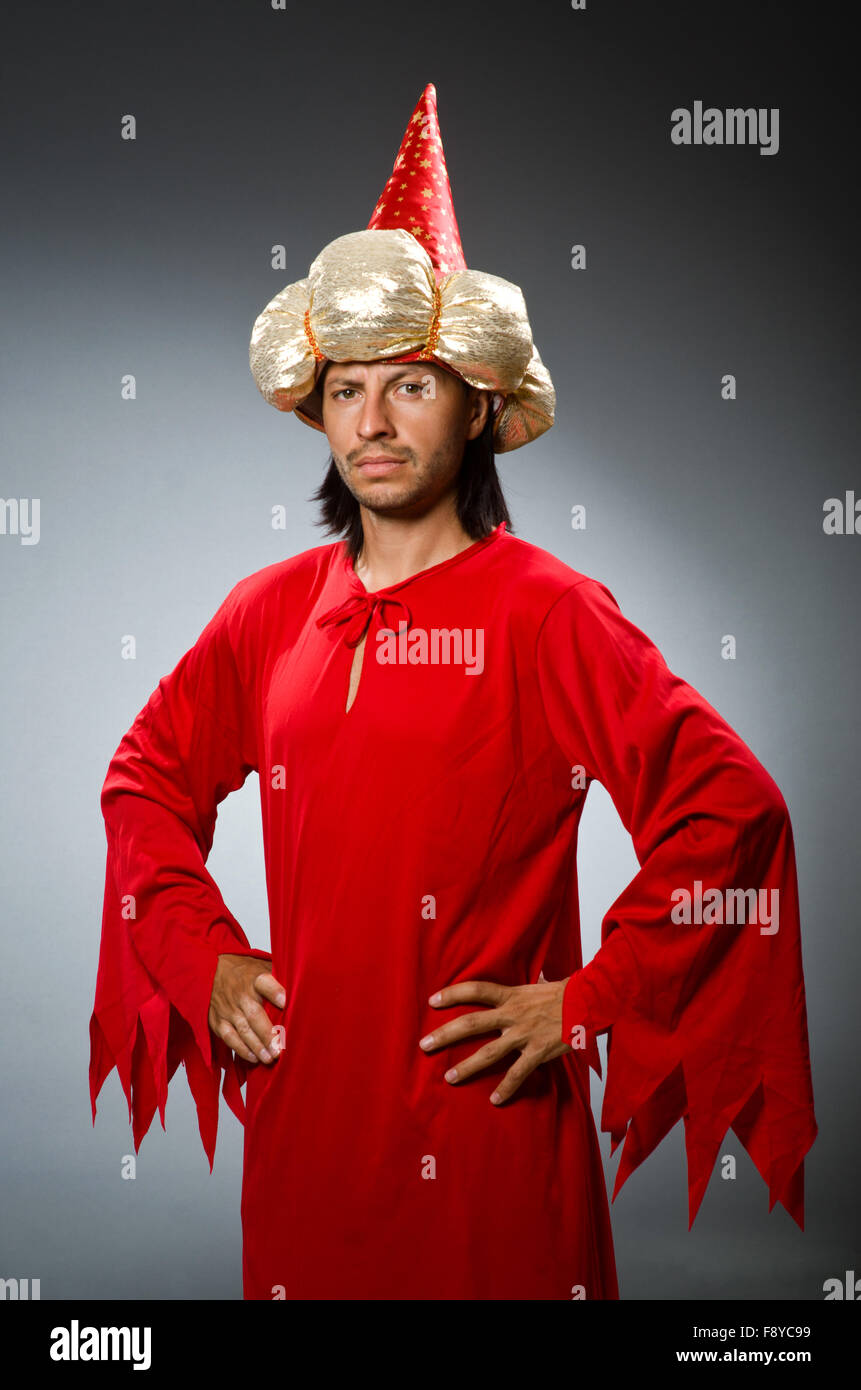 Funny wizard wearing red dress Stock Photo - Alamy
