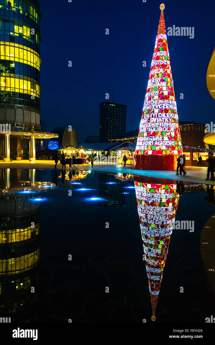 Christmas Tree made with illuminated signs bearing the words 'Best wishes' in all languages of the world, Milan, Italy Stock Photo