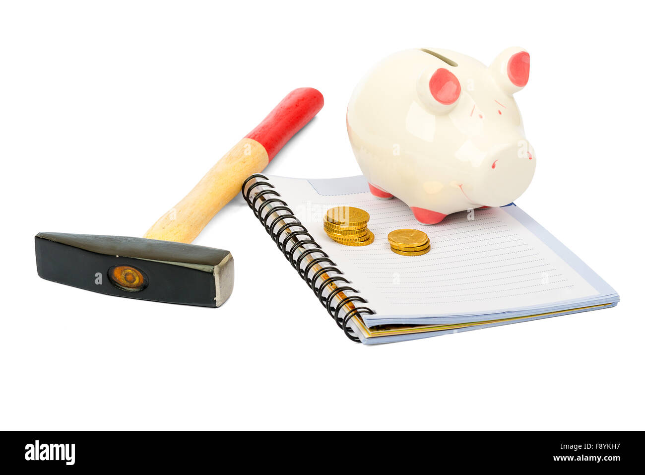 Piggy bank with hammer and coins Stock Photo - Alamy