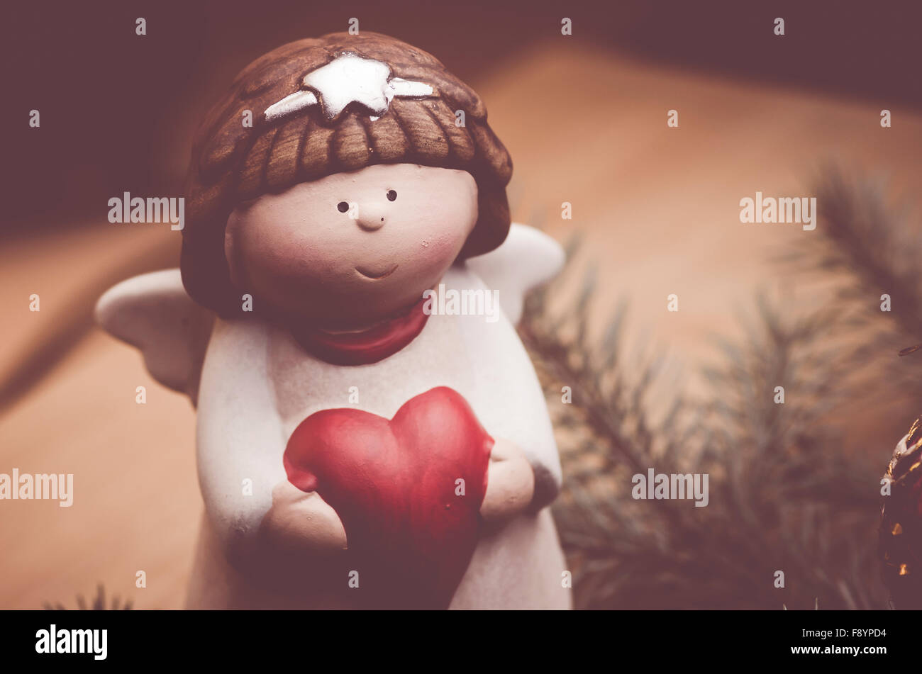 hand made angel christmas decoration on a fir neddles background - retro style Stock Photo