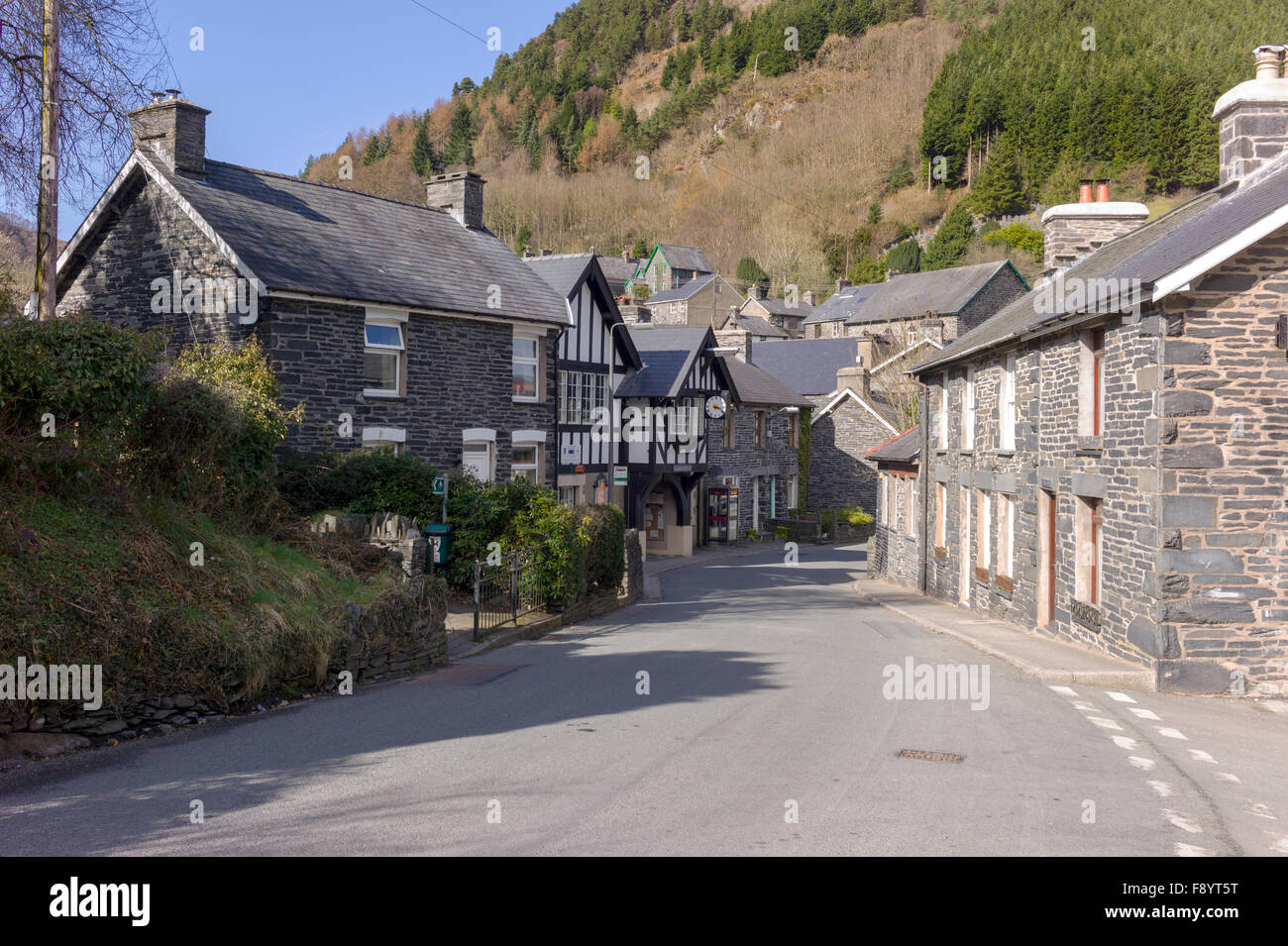 A view of Corris village main street with the black and white half timbered Corris Instittute amongst the small village houses. Stock Photo