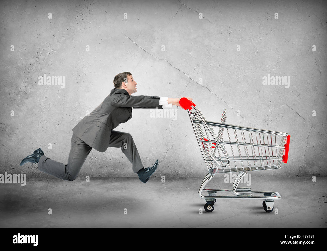 Businessman pushing shopping cart Stock Photo Alamy