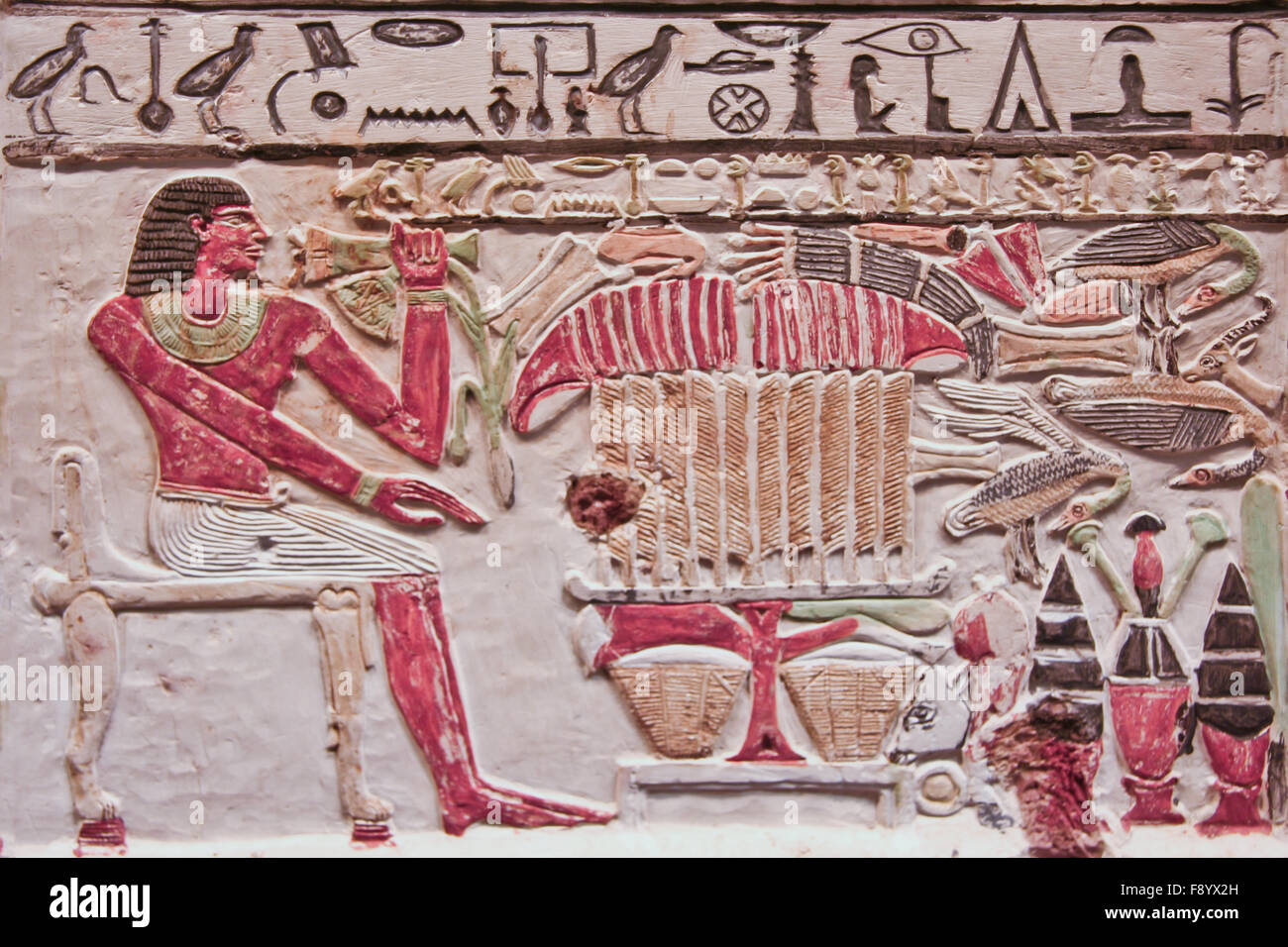 An Ancient Egyptian painted and carved relief on a wall Stock Photo