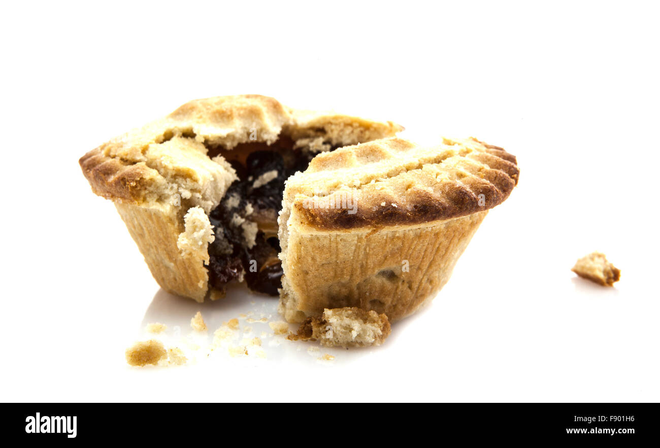 Mince Pie broken in half showing mince on white background Stock Photo