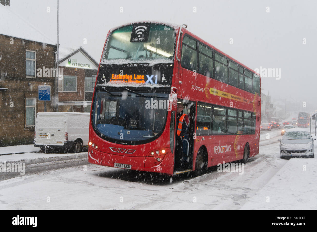 Gateshead UK, 12th Dec 2015. Snow brought traffic to a standstill on Sheriff Hill Gateshead. Here an X1 bus is unable to climb the hill with a further two buses also stuck behind Credit:  Washington Imaging/Alamy Live News Stock Photo