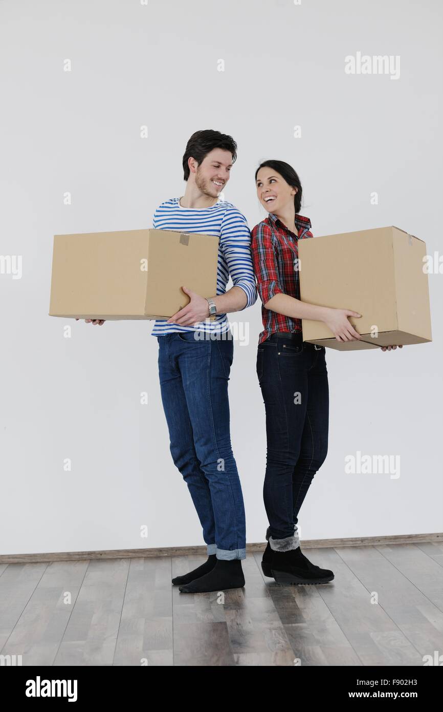 happy Young couple moving in new home Stock Photo - Alamy