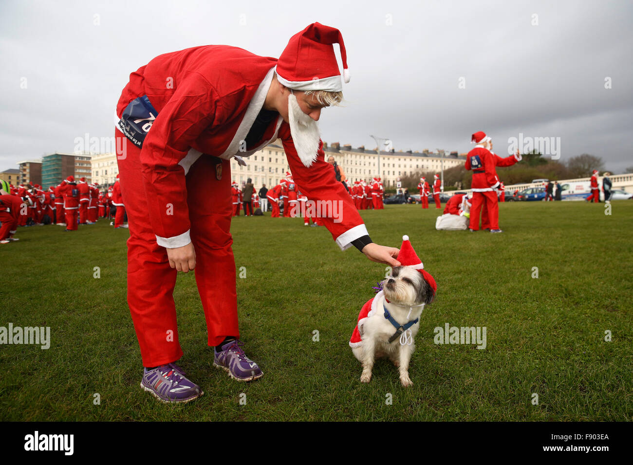 Brighton, UK. 12th December, 2015. A competitor adjusts, her dog, Meryl's costume dressed as Father Christmas before competing in the Santa Dash Brighton 2015 at Brighton, UK, Saturday December 12, 2015. Credit:  Luke MacGregor/Alamy Live News Stock Photo