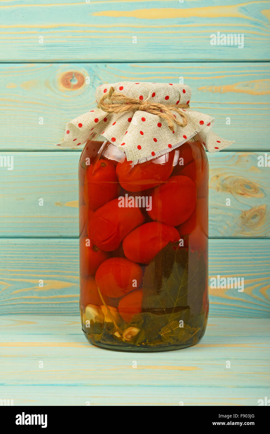 One Big Glass Jar Of Homemade Pickled Tomatoes With Dotted Textile