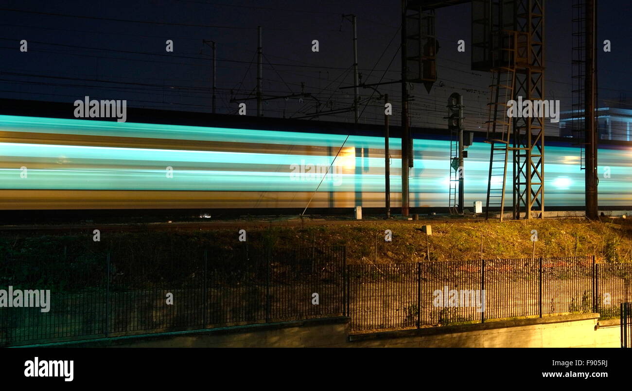 AJAXNETPHOTO. 2015. ROME, ITALY. - RAIL TRANSPORT - A NIGHT SCENE IN THE SUBURB OF SETTE BAGNI WITH A REGIONAL TRENITALIA DOUBLE DECKER PASSENGER TRAIN PASSING BY.  PHOTO:JONATHAN EASTLAND/AJAX REF:GX 151012 75815 Stock Photo