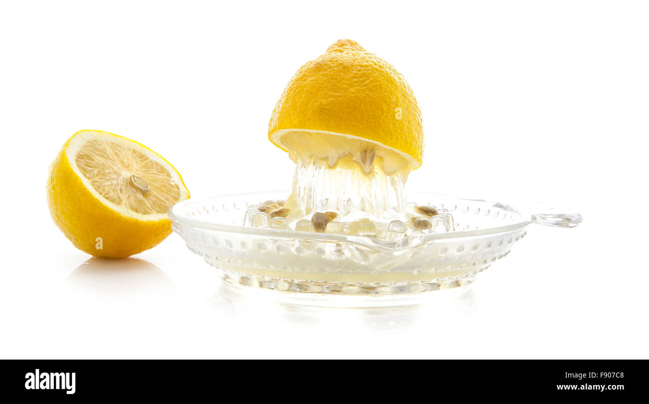 Glass citrus squeezer with lemons and juice on a white background Stock