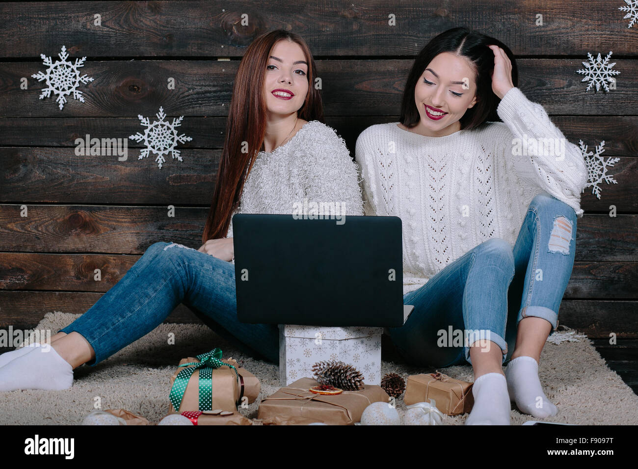 Two beautiful girls siting on the floor Stock Photo - Alamy