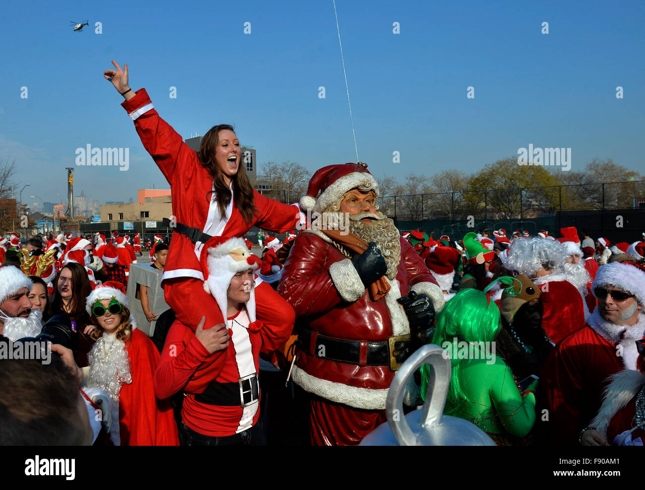 New York, USA. 12th Dec, 2015. People dressed as Santas take part in SantaCon 2015 in New York, the United States, on Dec. 12, 2015. SantaCon 2015 kicked off Saturday here in New York. SantaCon, a celebration that calls for attendees to dress as Santas and follow a pre-planned route of bar-hopping, is celebrated in cities across the U.S. and the world. Credit:  Wang Lei/Xinhua/Alamy Live News Stock Photo