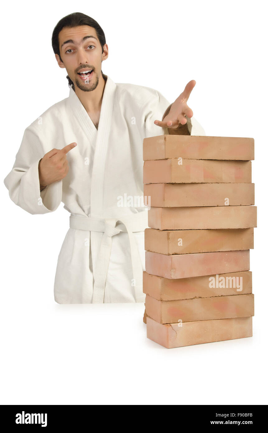 Karate man breaking bricks on white Stock Photo