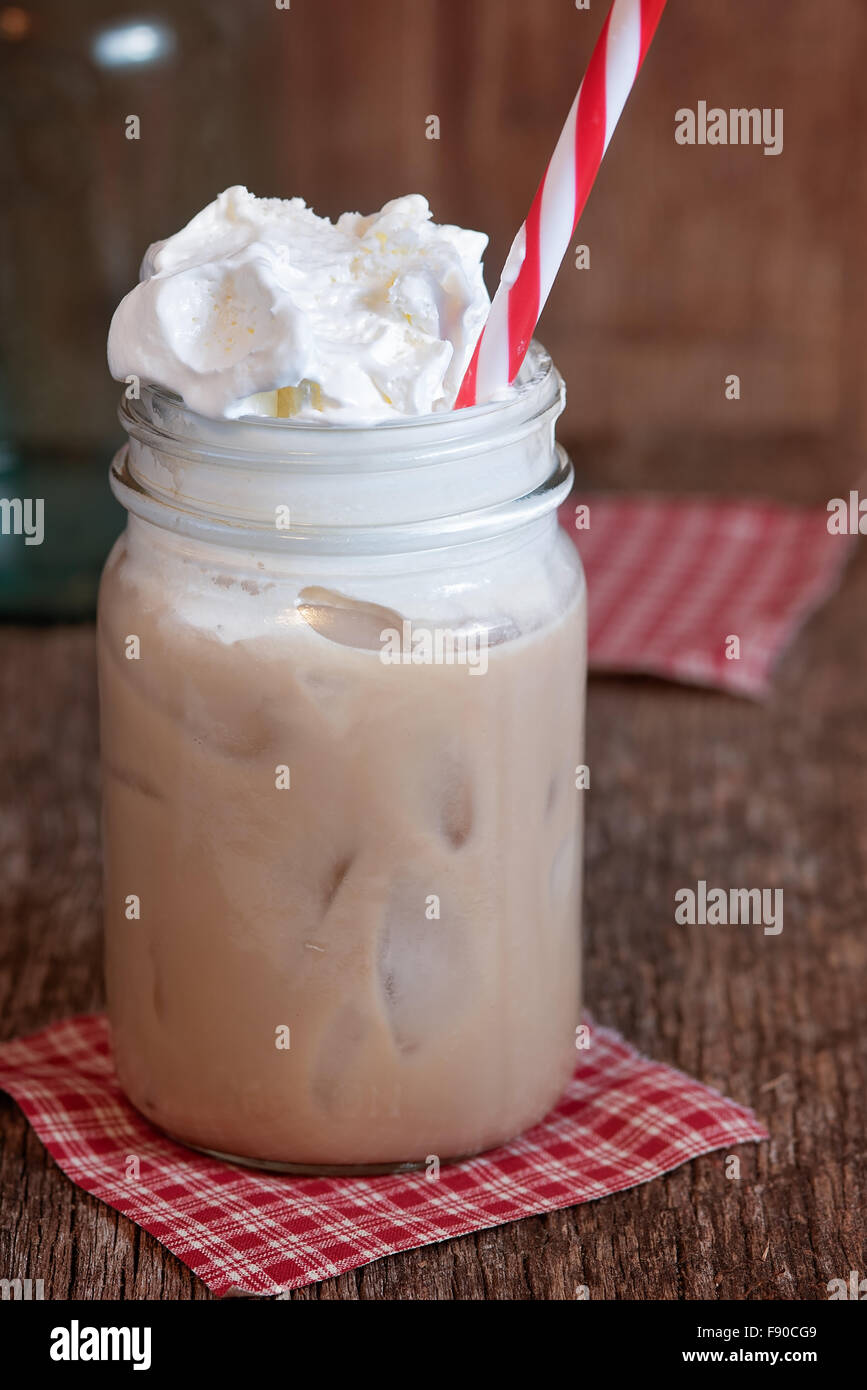 Iced coffee in jar, mug glass cup on the white table Stock Photo - Alamy