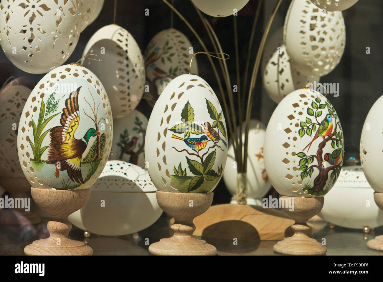 Colourful birds painted on delicate empty egg shells on sale, Budapest, Hungary. Stock Photo