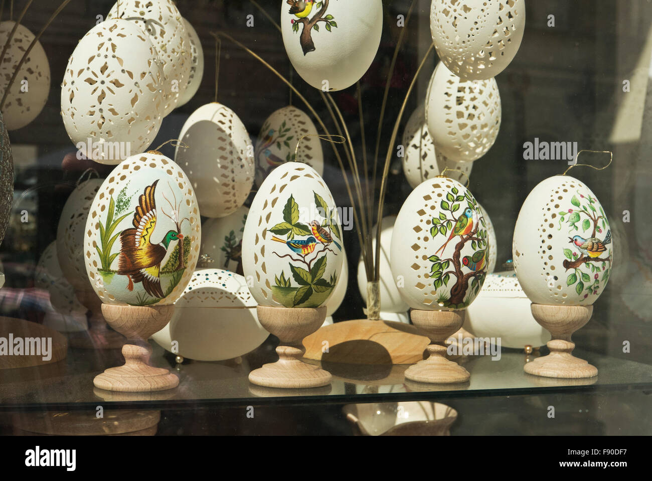 Colourful birds painted on delicate empty egg shells on sale, Budapest, Hungary. Stock Photo