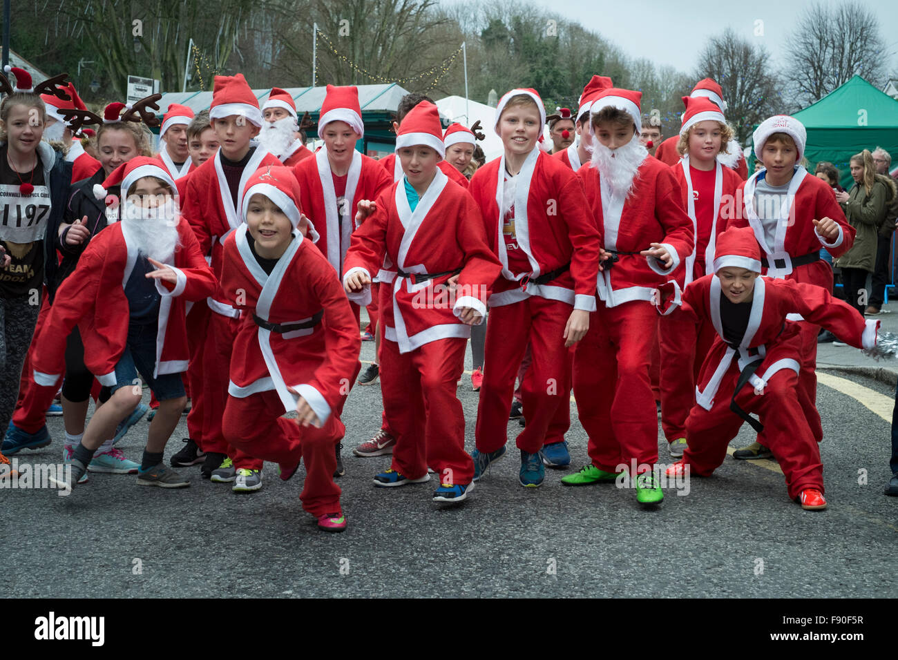 Falmouth, UK. 12th December, 2015. 100's of people took part in the Santa vs Rudolph fun run through Falmouth.  This is one in a series of 7 run, walk and surf events in the Santa series raising funds and awareness to support Cornwall Hospice Care. Credit:  Mick Buston/Alamy Live News Stock Photo