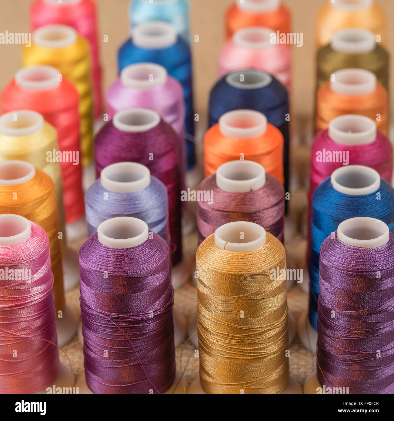 Spools of colorful embroidery thread in rows Stock Photo Alamy