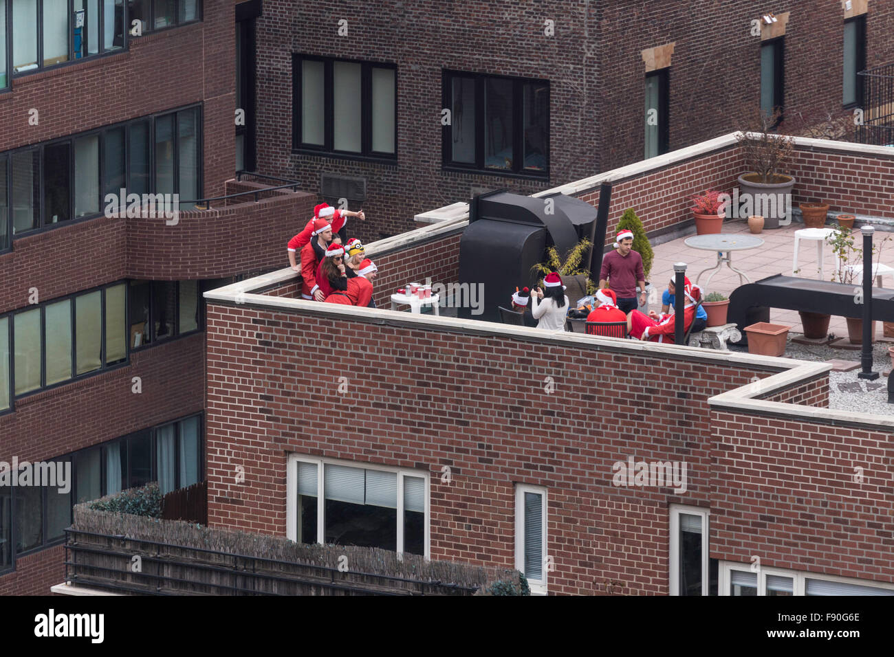 New York City, USA.  12 December 2015.  SantaCon has become a very popular pub crawl.  This group of Santa begins their activities by gathering on a roof deck in Midtown Manhattan. Credit:  Patti McConville/Alamy Live News Stock Photo