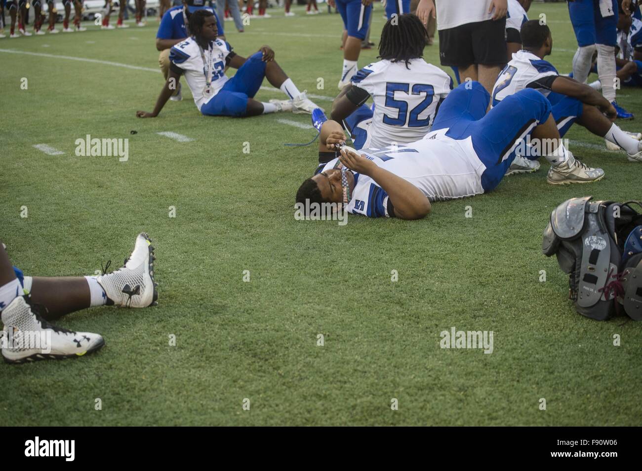 Florida, USA. 12th Dec, 2015. Zack Wittman | Times.Armwood's Malik Hunt-Cruz lies on the ground while he inspects his silver medal after losing 13-48 to Miami Central after Armwood High School's game against Miami Central Senior High School in the Class 6A 2015 FHSAA Football Finals on Saturday afternoon, December 12, 2015 at the Citrus Bowl in Orlando. © Tampa Bay Times/ZUMA Wire/Alamy Live News Stock Photo