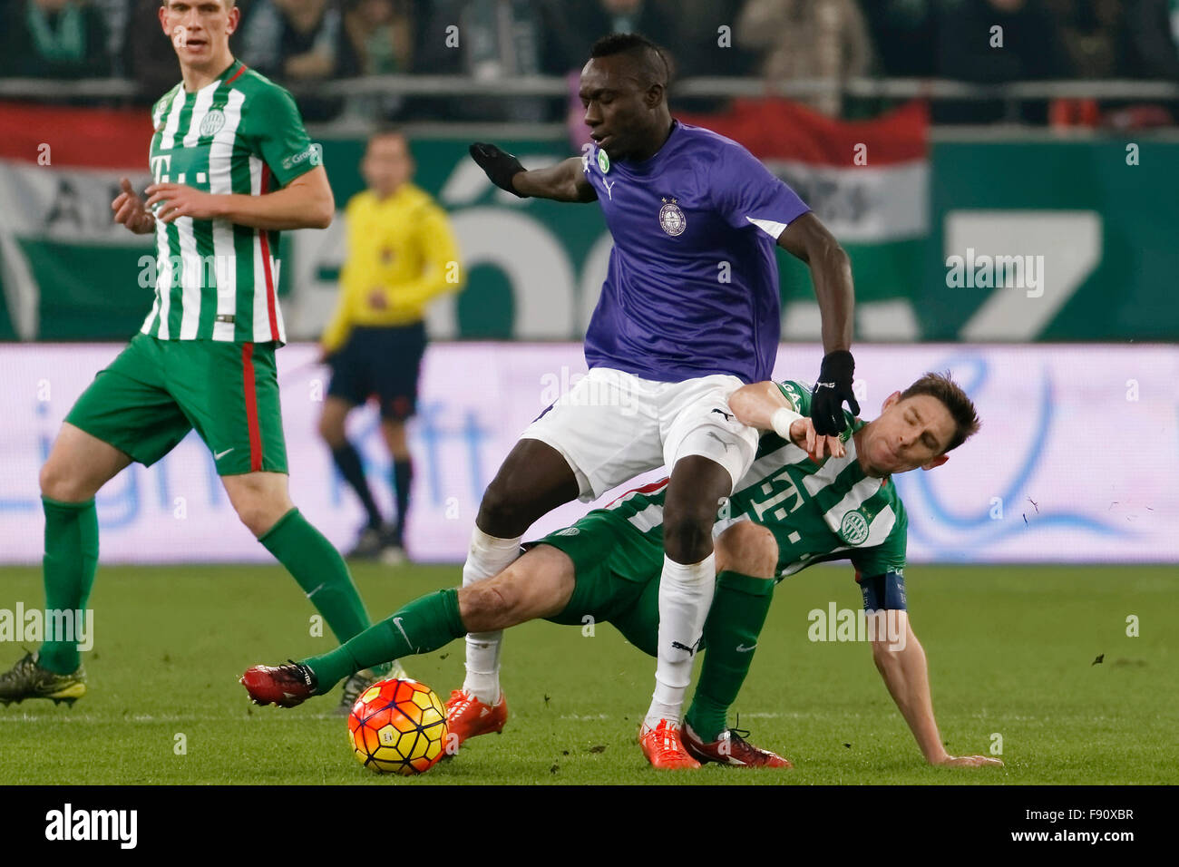 Budapest, Hungary. 12th December, 2015. Zoltan Gera of Ferencvaros (l) slides against Mbaye Diagne of Ujpest during Ferencvaros - Ujpest OTP Bank League football match at Groupama Arena. Credit:  Laszlo Szirtesi/Alamy Live News Stock Photo