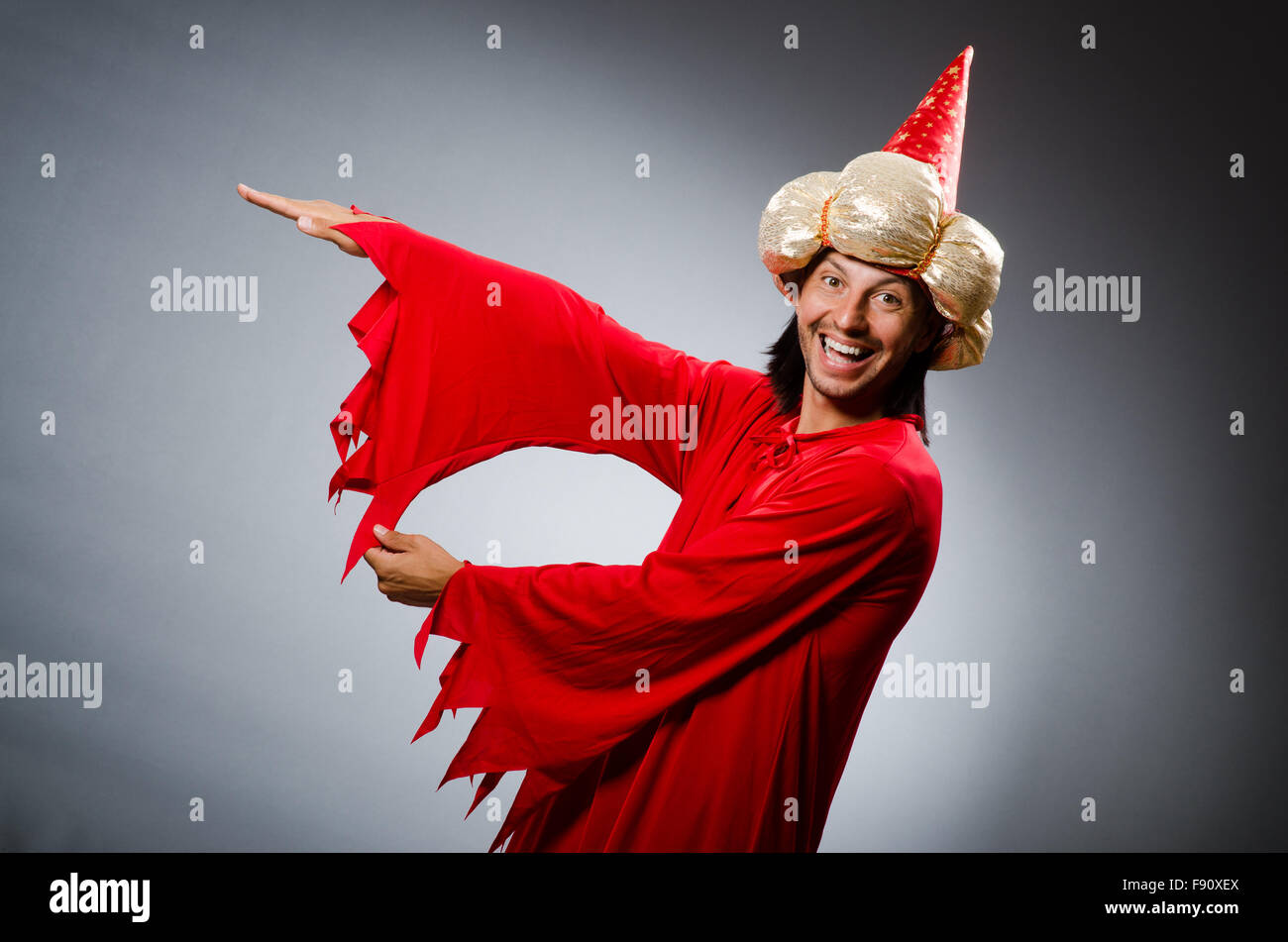 Funny wizard wearing red dress Stock Photo - Alamy